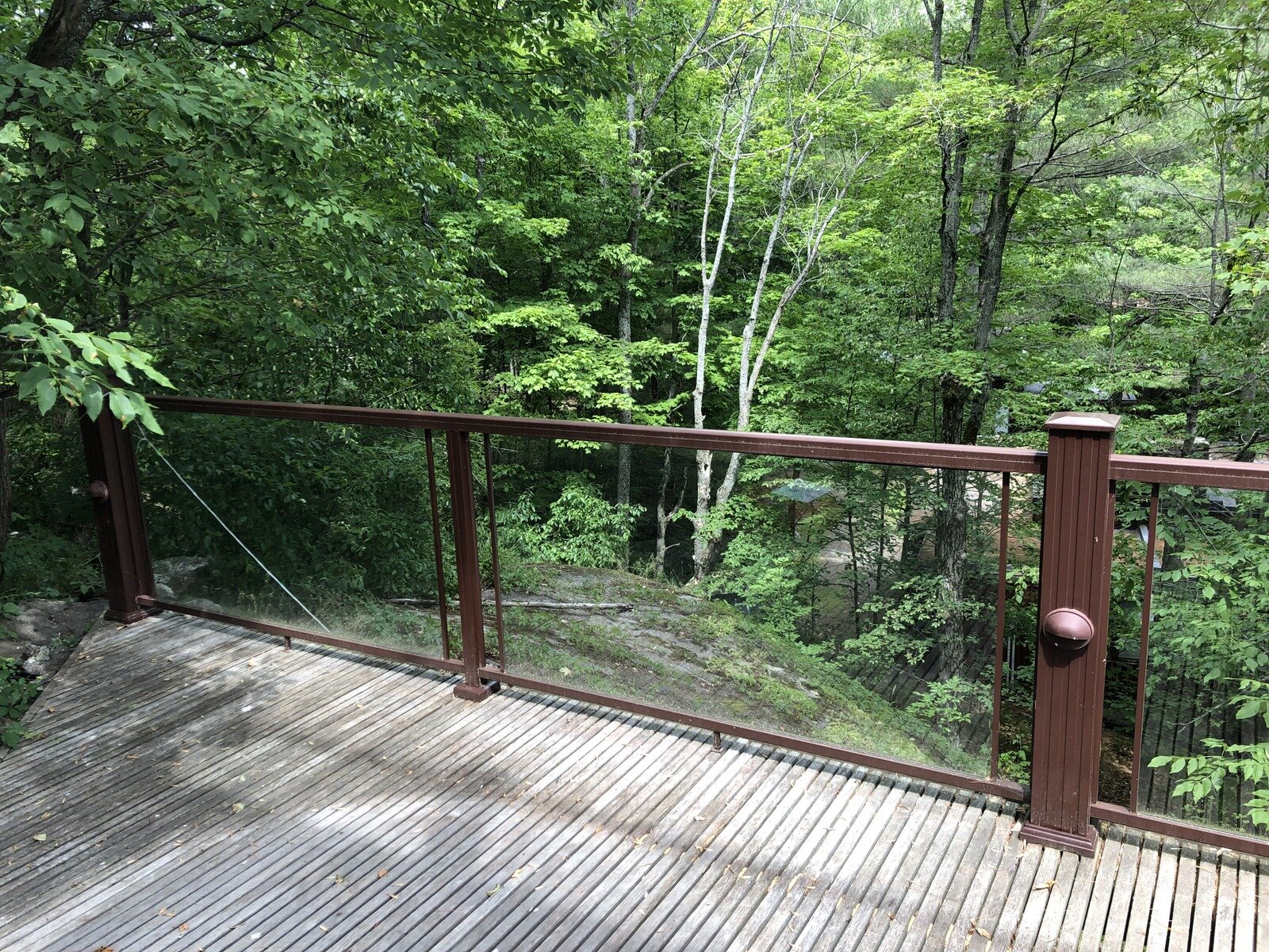 Setting the final track line means looking at every condition the completed lift will need to meet to integrate with the cottage and cottage life. This corner of a main cottage deck was both central and out of the way—the perfect spot for the upper station. Our goal was to set it as close to the back-left corner as we could.