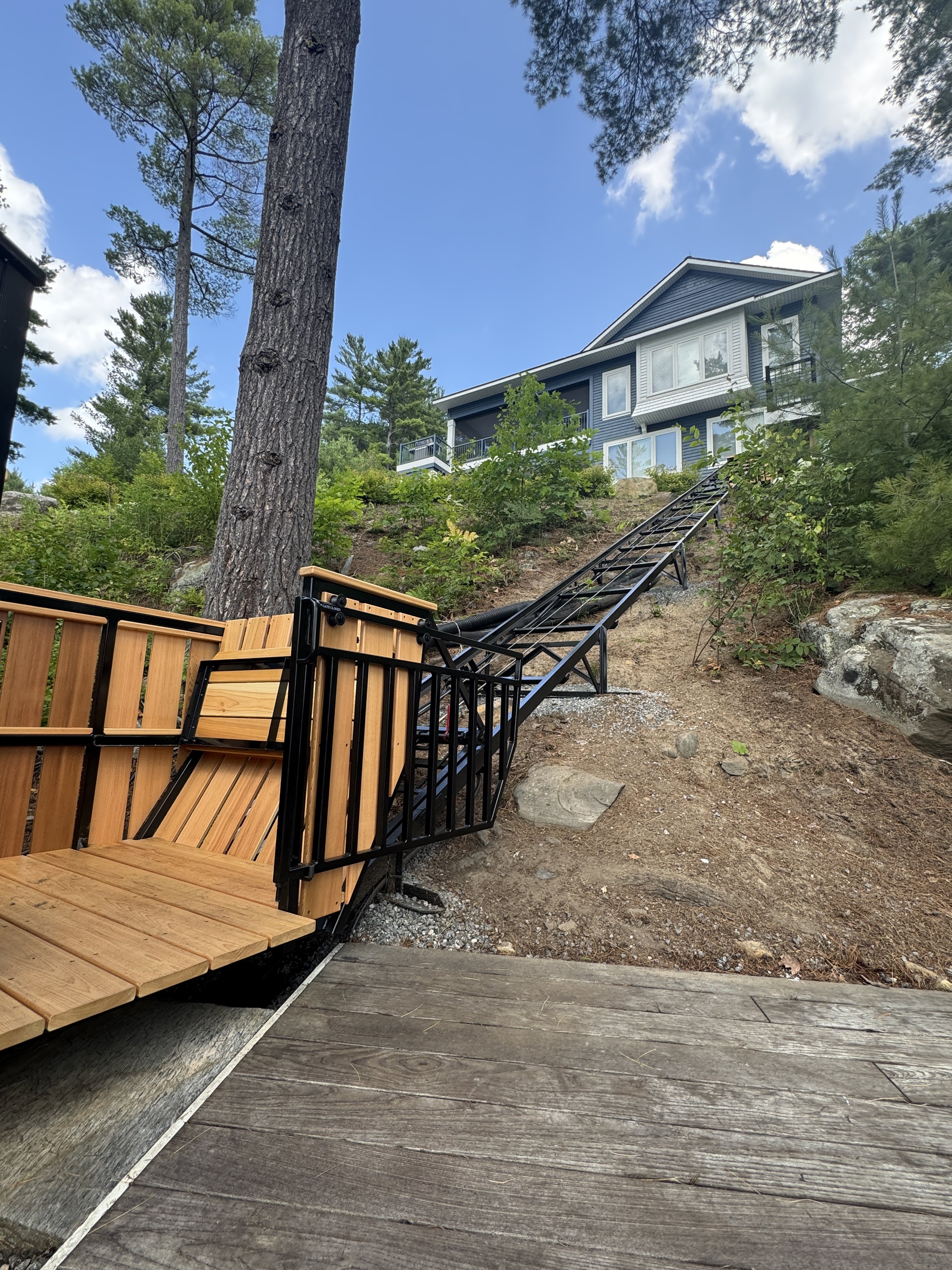 A clear view of the lift's path, stretching from the dock up to the cottage.