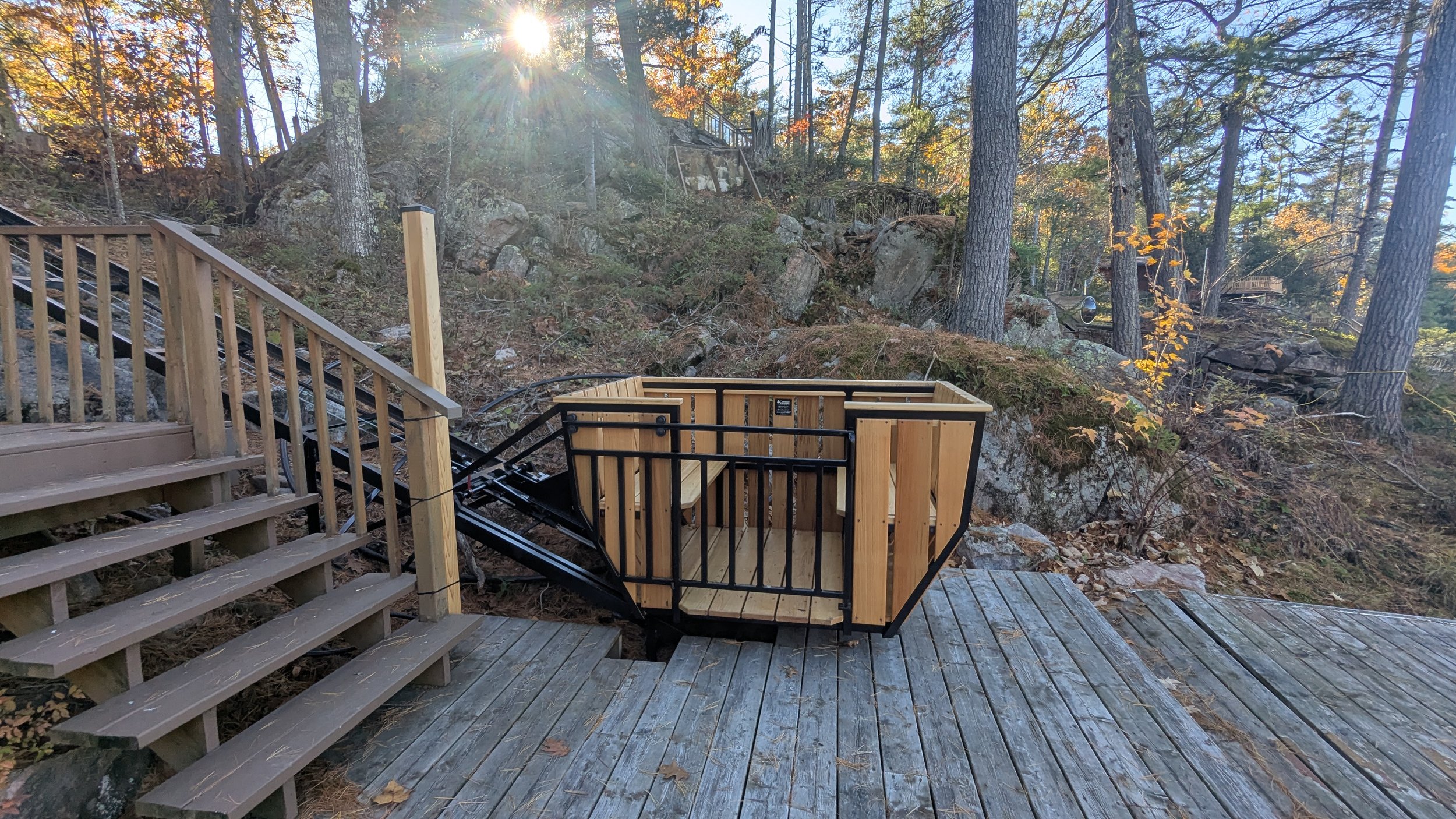 At the lower station, the car rests just above the existing deck, keeping the space open and inviting. When the lift is not in use, the PARK button sends the car up the track, opening up the lower deck for everyone to relax and enjoy the view.