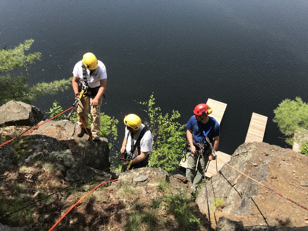 The build team's first foray onto the hill. The track follows a natural line in the rock. Before we started, a crew from Premier Docks cleared the loose rock off the cliff face.