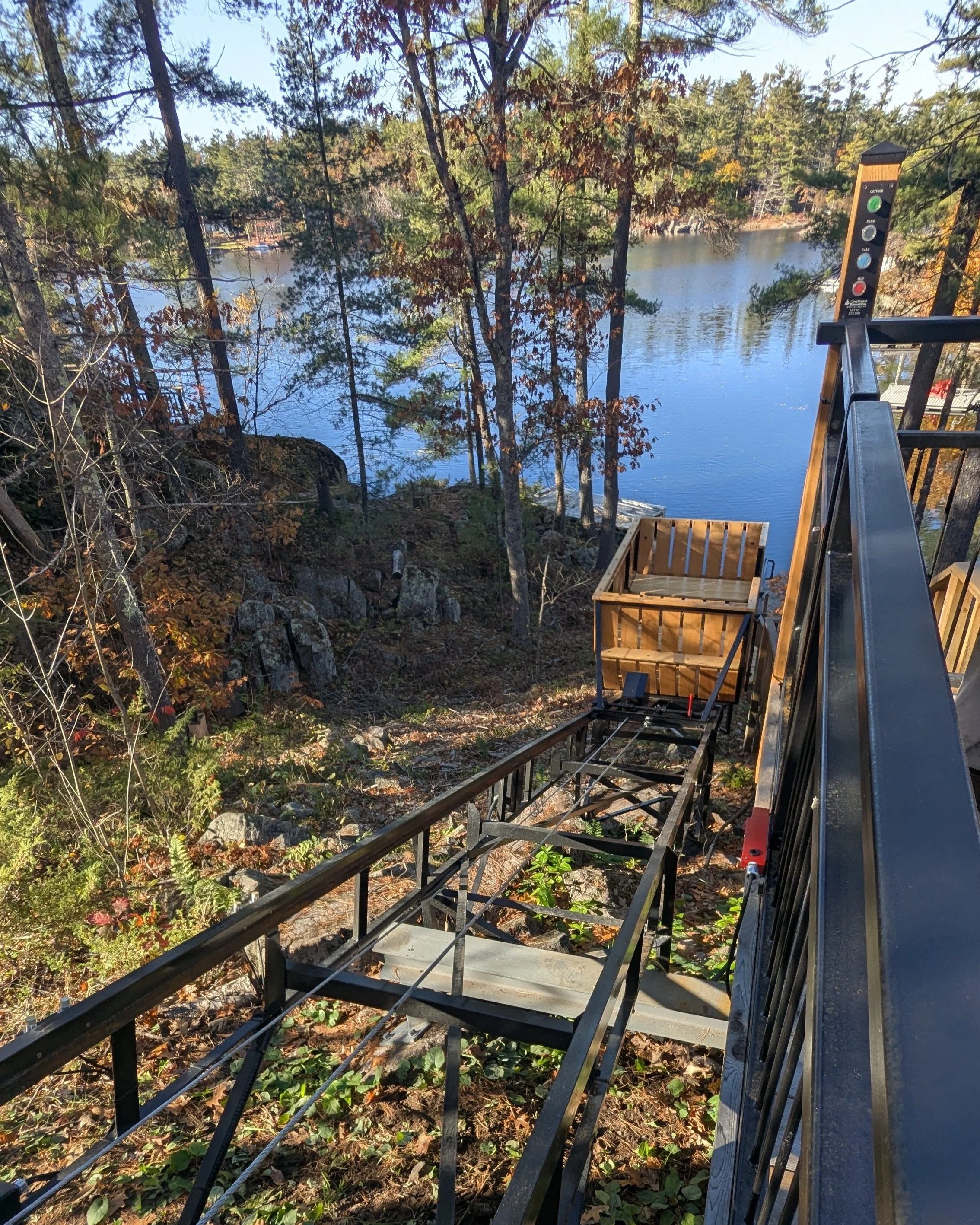The upper station's access gate is fully interlocked with the lift, ensuring safe operation at all times. The gate remains securely closed unless the car is in the station, preventing accidental entry onto the track.