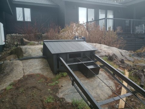 The old lift's car floor was about four feet off the ground and needed a platform and stairs. This one sits about nine inches up, making loading and unloading people and gear easy. The button box has a PARK button that moves the car 10 feet up the track and stops it there.
