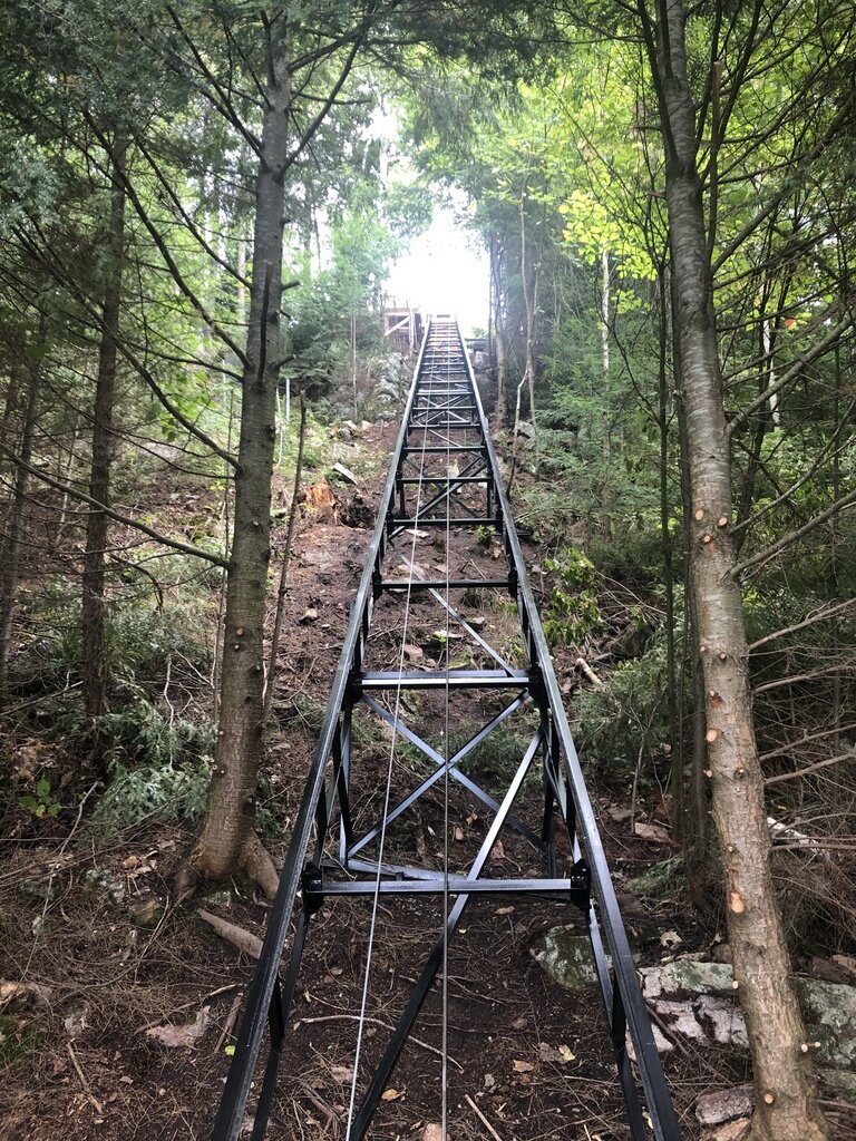View from the bottom. The lower station is discreetly tucked away at the far end of the space near the lakeside fire pit, a few steps from the dock. In this photo, the car sits about a foot from the bottom station.