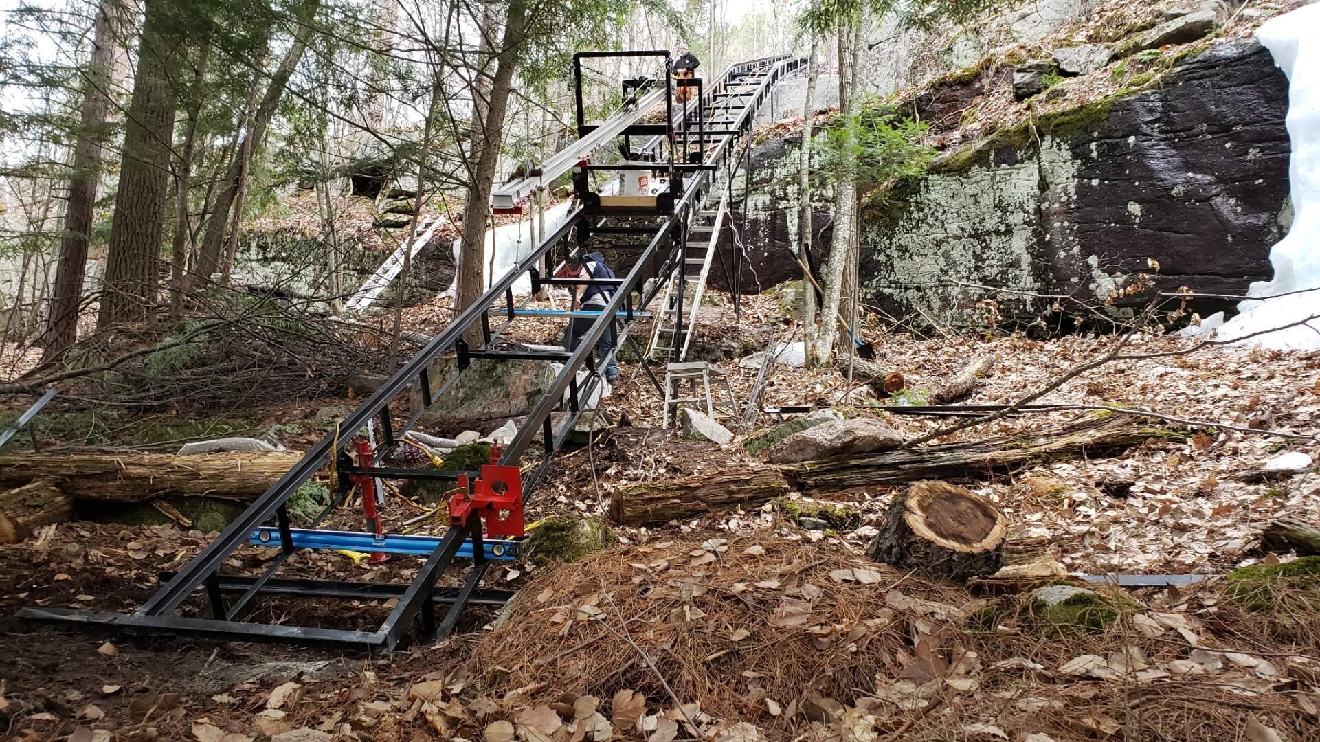 With the last piece of track in, the installation hoist continued to move crew and materials up and down the hill.