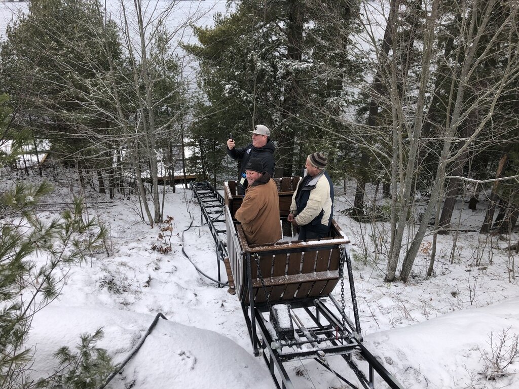 Jason and two of his crew heading down to work on the boathouse. We use industrial-quality components so our lifts can be used by construction and maintenance crews. Lift 24, for example, has well over 3,500 round trips, and Lift 29 was used to haul 56 metric tons of sand and gravel up a hill to build a septic system at an island cottage.