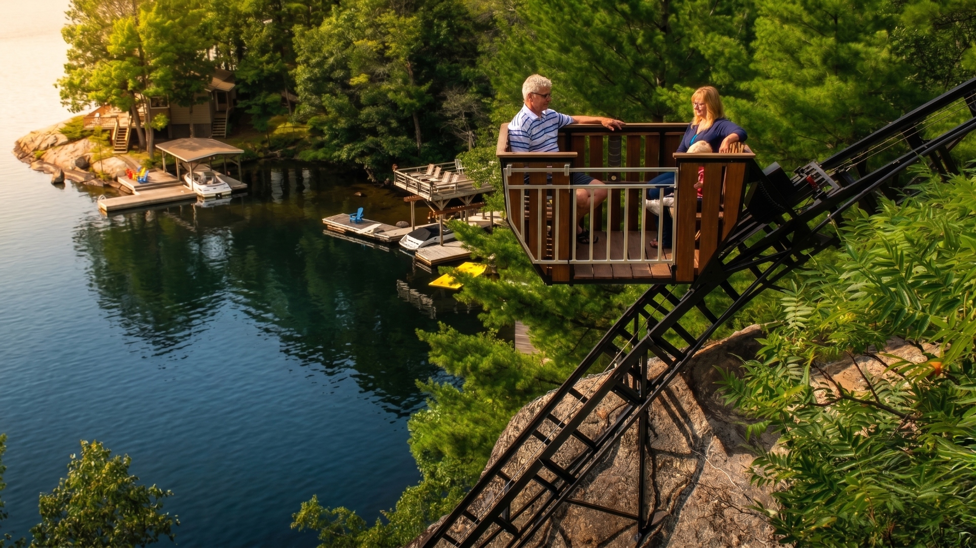 An Inclined Elevation lift carrying passengers above a Muskoka lake shoreline